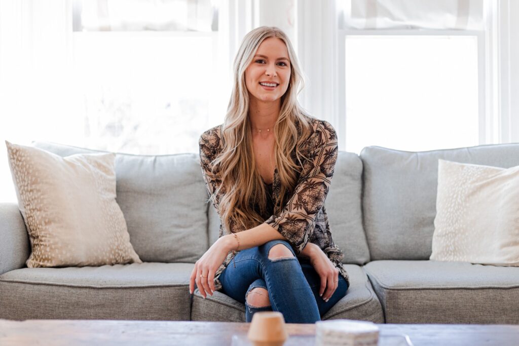 Kendra sitting on couch smiling